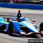 인디카 레이싱 머신 특성 - 2-liter V6 twin-turbo engine's power is palpable, with heat shimmering above the exhaust. The driver...